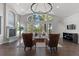 Bright living room with a fireplace, hardwood floors, vaulted ceilings, and large windows offering wooded views at 166 S Rainbow Trl, Evergreen, CO 80439