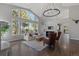 Spacious living room with high ceilings, large windows, hardwood floors, and a decorative chandelier at 166 S Rainbow Trl, Evergreen, CO 80439