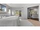 Bright main bedroom featuring plush carpet, natural light, and access to a deck at 166 S Rainbow Trl, Evergreen, CO 80439