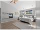 Bright main bedroom with a fireplace, plush rug, and views of the outdoors at 166 S Rainbow Trl, Evergreen, CO 80439