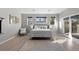 Serene main bedroom featuring plush carpet, natural light, and access to a deck at 166 S Rainbow Trl, Evergreen, CO 80439