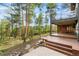Outdoor patio with steps, and stairs surrounded by mature trees and landscaping at 166 S Rainbow Trl, Evergreen, CO 80439