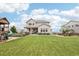 Expansive backyard featuring lush lawn, play area, and outdoor dining space, perfect for entertaining at 16881 E 110Th Ave, Commerce City, CO 80022