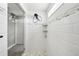 Bright bathroom features a modern shower design, sleek fixtures, and built-in shelving for added convenience at 16881 E 110Th Ave, Commerce City, CO 80022