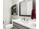 Bathroom featuring a gray vanity with white marble countertop, a sink, mirror, and decor at 16881 E 110Th Ave, Commerce City, CO 80022