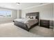 Bedroom featuring a bed with grey headboard, two nightstands, and a large window with lots of natural light at 16881 E 110Th Ave, Commerce City, CO 80022