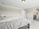 Neutral bedroom features a comfortable bed with a private ensuite bathroom at 16881 E 110Th Ave, Commerce City, CO 80022