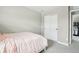 Bedroom with a soft pink comforter on the bed and a closet with sliding doors at 16881 E 110Th Ave, Commerce City, CO 80022