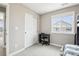 Bedroom area featuring a modern desk, a chair, and a closet with sliding doors at 16881 E 110Th Ave, Commerce City, CO 80022