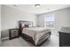 Neutral bedroom features a large bed, window, bedside tables, and carpeted floors at 16881 E 110Th Ave, Commerce City, CO 80022