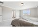 Neutral bedroom featuring a comfortable bed with a large window and an adjacent bathroom at 16881 E 110Th Ave, Commerce City, CO 80022
