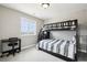 Comfortable bedroom featuring a bunk bed with a stylish grey and white striped comforter and black desk at 16881 E 110Th Ave, Commerce City, CO 80022