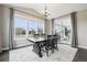 Charming dining area with natural light, a view to the patio, and a dark wood table at 16881 E 110Th Ave, Commerce City, CO 80022