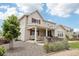 Attractive home exterior featuring a covered patio, landscaping, and a well-maintained yard for outdoor enjoyment at 16881 E 110Th Ave, Commerce City, CO 80022