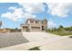 Expansive two-story home boasting a three-car garage, stone accents, and a spacious driveway at 16881 E 110Th Ave, Commerce City, CO 80022