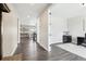 Hallway view includes a living space, entryway, and office space with dark hardwood floors at 16881 E 110Th Ave, Commerce City, CO 80022