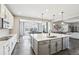 This kitchen features a large island with bar stool seating and stainless steel appliances at 16881 E 110Th Ave, Commerce City, CO 80022