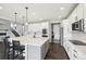 This kitchen features a large island with bar stool seating and stainless steel appliances at 16881 E 110Th Ave, Commerce City, CO 80022