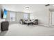 Spacious living room with a comfortable grey sofa and decorative pillows, illuminated by natural light from two windows at 16881 E 110Th Ave, Commerce City, CO 80022