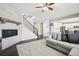 Inviting living room featuring a cozy fireplace, elegant staircase, and hardwood floors at 16881 E 110Th Ave, Commerce City, CO 80022