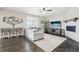 Bright living room with hardwood floors, stylish furniture, and a modern fireplace at 16881 E 110Th Ave, Commerce City, CO 80022
