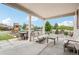 Inviting covered patio area with comfortable seating and dining options, ideal for outdoor relaxation and gatherings at 16881 E 110Th Ave, Commerce City, CO 80022