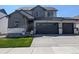 Charming two-story home featuring a well-manicured lawn, two-car garage, and neutral exterior at 16815 Mckay Dr, Mead, CO 80542