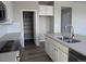 Close-up of the kitchen featuring white cabinets, stainless appliances, and a pantry at 16815 Mckay Dr, Mead, CO 80542