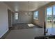 Open-concept living room with hardwood floors, large windows, and a modern chandelier at 16815 Mckay Dr, Mead, CO 80542
