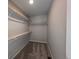 Spacious walk-in closet with carpeted floor and wood shelving for optimized storage solutions at 16815 Mckay Dr, Mead, CO 80542