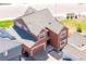 Aerial view of a two story home with a gray roof, attached garage, and solar panels at 8372 Bijou Creek Ave, Littleton, CO 80125