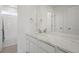A clean bathroom features a white marble countertop, an undermount sink, and white subway tile in the shower at 8372 Bijou Creek Ave, Littleton, CO 80125