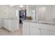 Bright bathroom with double vanity sinks, granite countertops, and a view into a walk-in closet at 8372 Bijou Creek Ave, Littleton, CO 80125