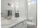 Bathroom with white vanity, marble countertop, brushed gold faucet and glass-enclosed shower at 8372 Bijou Creek Ave, Littleton, CO 80125