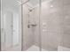 Modern bathroom with glass door shower, tiled walls, and built-in seat at 8372 Bijou Creek Ave, Littleton, CO 80125
