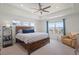 Comfortable primary bedroom includes a sitting area, ceiling fan, and views of the surrounding neighborhood at 8372 Bijou Creek Ave, Littleton, CO 80125