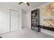 Bedroom featuring a ceiling fan, gray bookcase filled with books, and a wall map at 8372 Bijou Creek Ave, Littleton, CO 80125