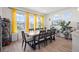 Spacious dining room with natural light that complements an expansive table with seating for eight at 8372 Bijou Creek Ave, Littleton, CO 80125