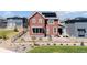 Attractive two-story home with solar panels, a fenced yard, and professional landscaping at 8372 Bijou Creek Ave, Littleton, CO 80125