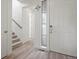 Bright, modern foyer with hardwood floors, staircase, and a white front door with sidelight at 8372 Bijou Creek Ave, Littleton, CO 80125