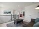 A second story hallway features a black coffee table, a gray love seat, and an accent painting at 8372 Bijou Creek Ave, Littleton, CO 80125