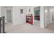 A hallway features a red bookcase filled with books, and a view into a bedroom at 8372 Bijou Creek Ave, Littleton, CO 80125