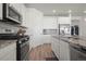 Modern kitchen with stainless steel appliances and granite countertops offers a chef's dream at 8372 Bijou Creek Ave, Littleton, CO 80125