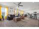 Open-concept living room features modern furniture, bright yellow curtains, and lots of natural light at 8372 Bijou Creek Ave, Littleton, CO 80125