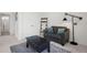 Living room with a black coffee table, a gray love seat, and a ladder with a blanket at 8372 Bijou Creek Ave, Littleton, CO 80125