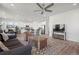 Spacious open-concept living room with hardwood floors, a ceiling fan, and a view of the kitchen at 8372 Bijou Creek Ave, Littleton, CO 80125