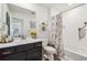 Bright bathroom with marble vanity, decorative mirror, and a shower with a stylish curtain at 9503 Richfield St, Commerce City, CO 80022