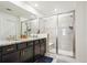 Modern bathroom with dual sinks, granite countertops, and a spacious glass-enclosed shower at 9503 Richfield St, Commerce City, CO 80022