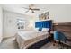 Comfortable bedroom with a stylish blue headboard, desk, and a ceiling fan at 9503 Richfield St, Commerce City, CO 80022