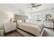 Comfortable bedroom with a tufted headboard, stylish nightstands, and modern decor at 9503 Richfield St, Commerce City, CO 80022